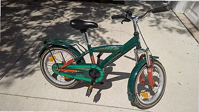 Kid's green bike with 16" wheels, perfect for neighborhood family bike rides